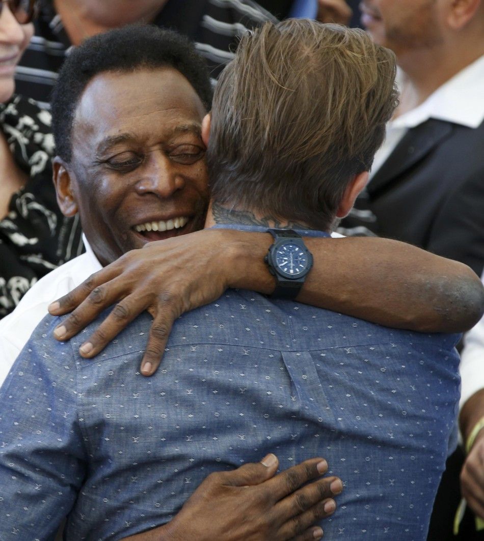 Brazils soccer legend Pele rear hugs former England soccer captain David Beckham during the 2014 World Cup closing ceremony at the Maracana stadium in Rio de Janeiro July 13, 2014.     REUTERSPaulo Whitaker BRAZIL  - Tags WORLD CUP SPORT SOCCER SOCI