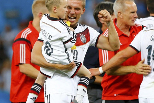 Germany's Lukas Podolski carries his child, Louis Gabriel Podolski,