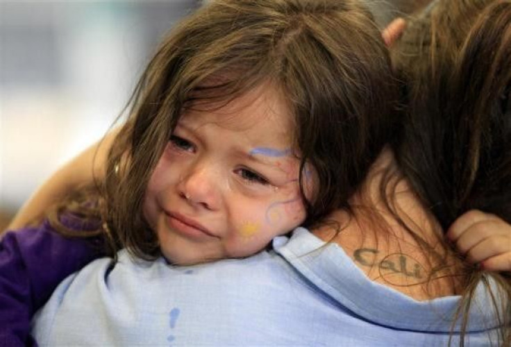 Cali Farmer, 4, (L) cries as she hugs her mother Netta Farmer at California Institute for Women state prison in Chino, California May 5, 2012.