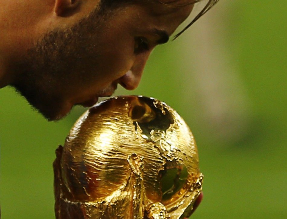 Germanys Mario Goetze kisses the World Cup trophy as he celebrates their 2014 World Cup final win against Argentina at the Maracana stadium in Rio de Janeiro July 13, 2014.