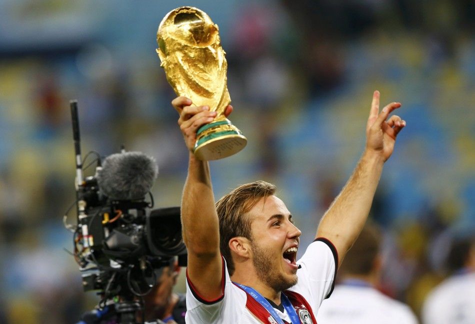 Germanys Mario Goetze holds up the World Cup trophy as he celebrates their 2014 World Cup final win against Argentina at the Maracana stadium in Rio de Janeiro July 13, 2014.