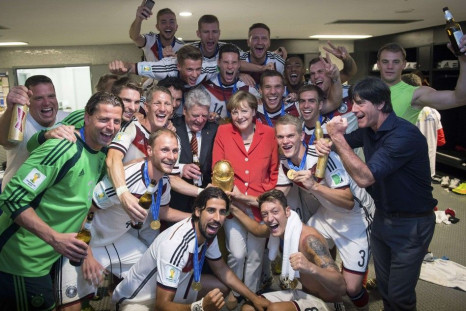 German Chancellor Angela Merkel (centre R) and German President Joachim Gauck (centre L) pose with the Germany's coach Joachim Loew (front R) and his players
