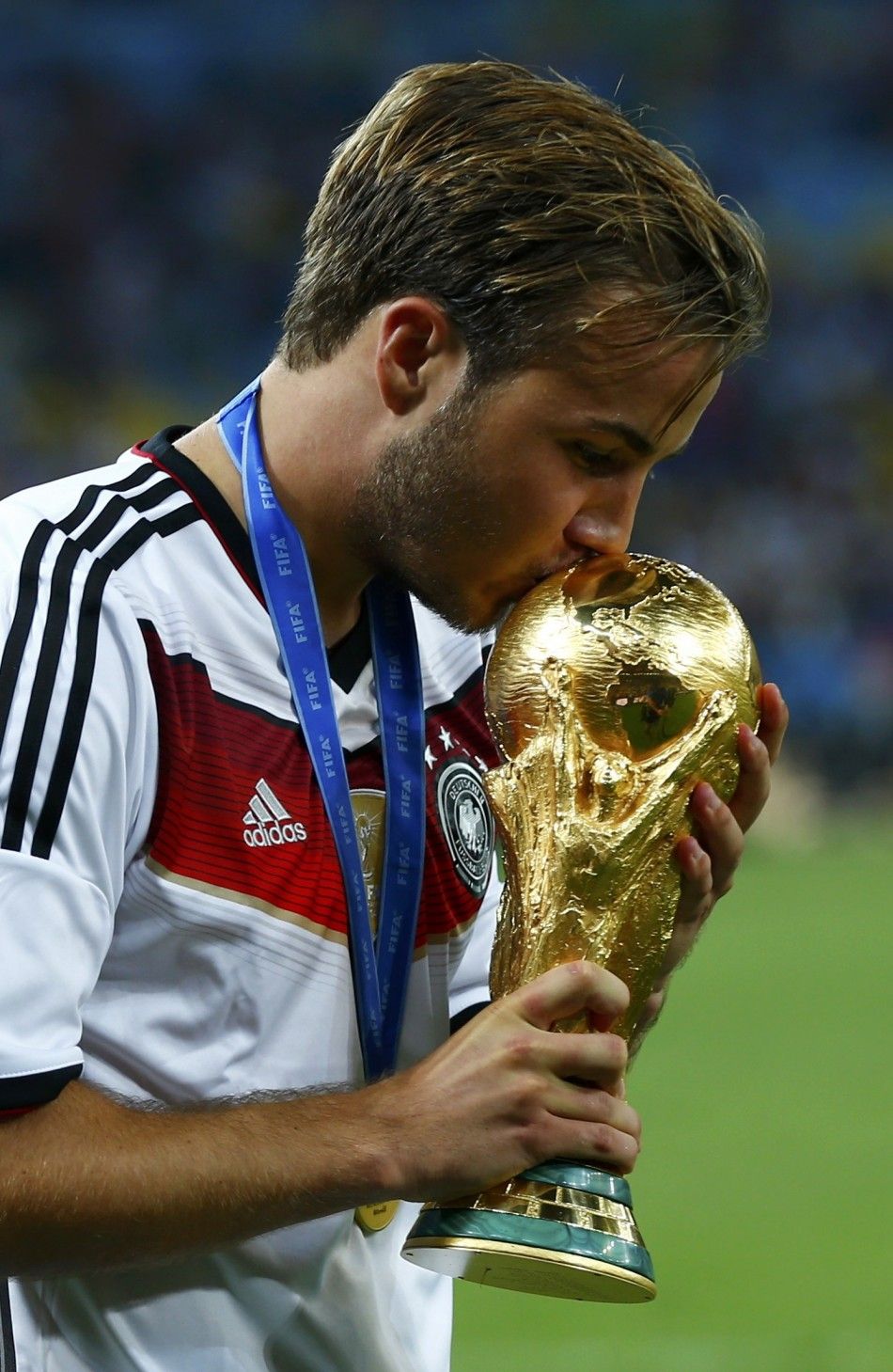 Germanys Mario Goetze kisses the World Cup trophy after the 2014 World Cup final against Argentina at the Maracana stadium in Rio de Janeiro July 13, 2014. 