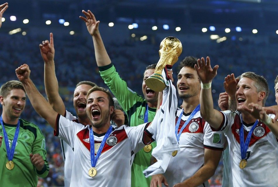 Germanys Mario Goetze 3rd L celebrates with the World Cup trophy after winning their 2014 World Cup final against Argentina at the Maracana stadium in Rio de Janeiro July 13, 2014.