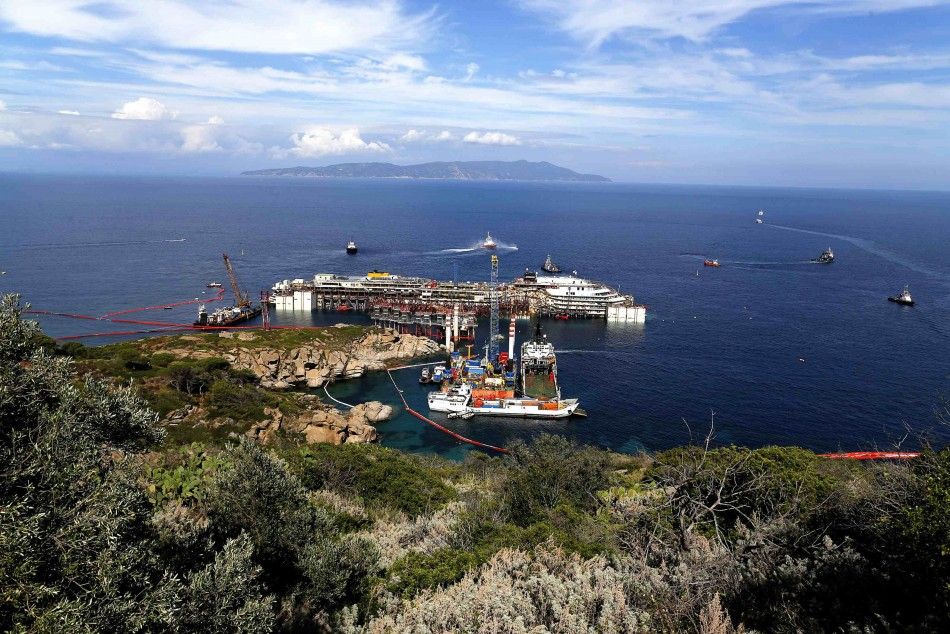 The cruise liner Costa Concordia is seen at Giglio harbour at Giglio Island July 13, 2014. Italian authorities gave the green light to refloating the wrecked Costa Concordia cruise ship on Saturday, setting the stage for the next step in the largest marit