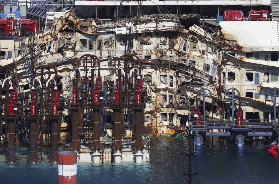 A damaged part of the cruise liner Costa Concordia is seen at Giglio harbour, Giglio Island July 13, 2014. Italian authorities gave the green light to refloating the wrecked Costa Concordia cruise ship on Saturday, setting the stage for the next step in t