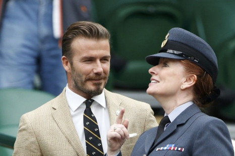 Former England soccer captain David Beckham arrives on Centre Court at the Wimbledon Tennis Championships, in London