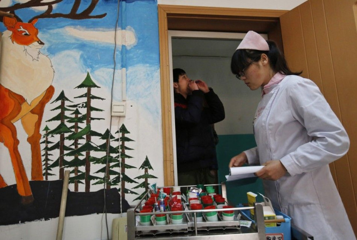 A nurse distributes medicine at Daxing Internet Addiction Treatment Center in Beijing
