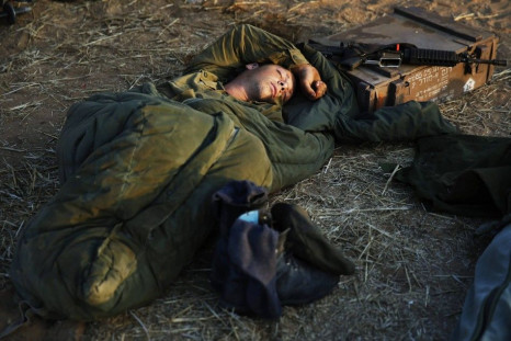 An Israeli soldier sleeps near the central Gaza Strip