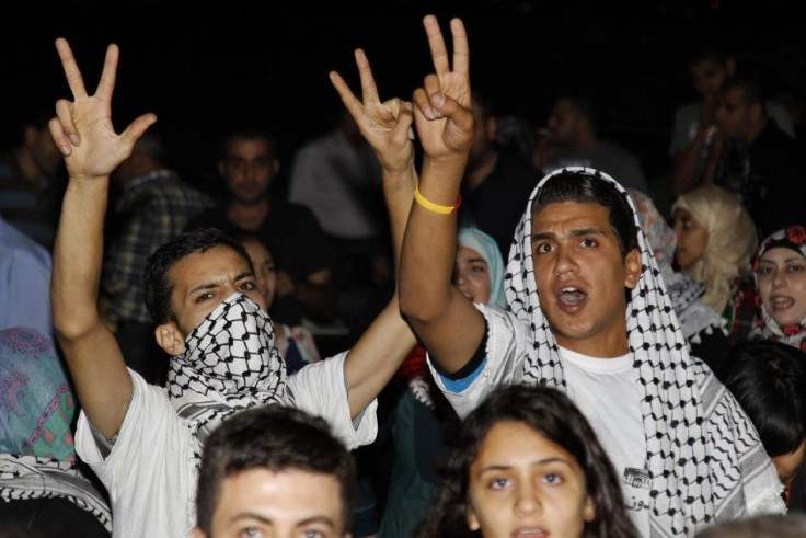 Protesters gesture during a protest near the Israeli embassy in Amman, calling for an end to Israeli air strikes in the Gaza Strip