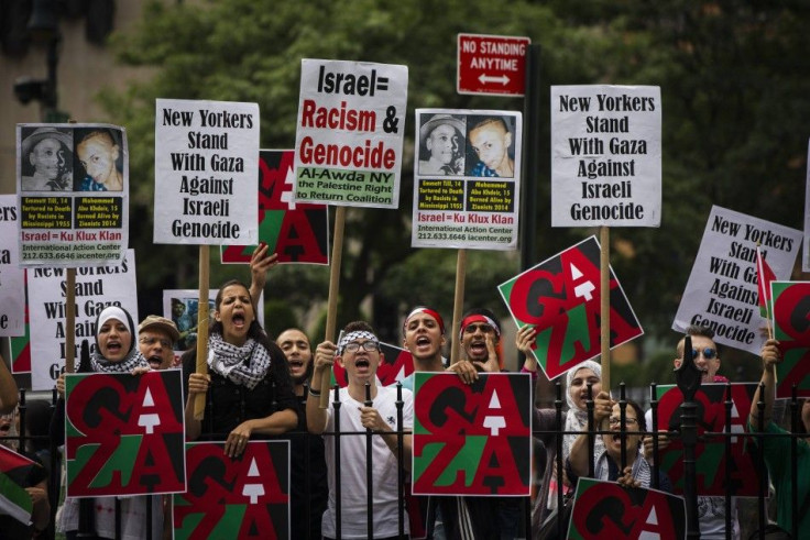 Pro-Palestinian demonstrators display signs outside of New York City hall, where a pro-Israel rally organised by local Jewish communities is taking place, in New York