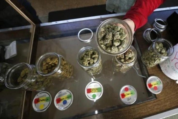 A Volunteer Displays Jars of Dried Cannabis Buds at the La Brea Collective Medical Marijuana Dispensary in Los Angeles