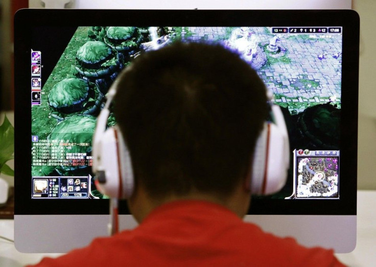 A man plays a computer game at an internet cafe