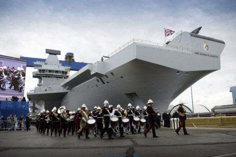 A military band performs during a naming ceremony for the Royal Navy warship HMS Queen Elizabeth at the Rosyth dockyard in Fife in this July 4, 2014 handout photo provided by Britain's Ministry of Defence (MoD). Queen Elizabeth officially named the b
