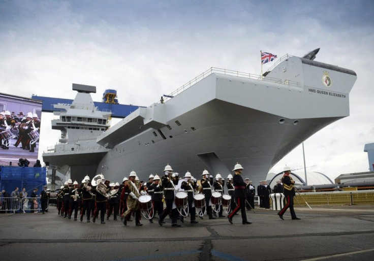 A military band performs during a naming ceremony for the Royal Navy warship HMS Queen Elizabeth at the Rosyth dockyard in Fife in this July 4, 2014 handout photo provided by Britain's Ministry of Defence (MoD). Queen Elizabeth officially named the b