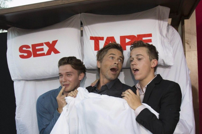 Cast member Rob Lowe (C) poses in a photo booth with his son Johnowen (R) and actor Patrick Schwarzenegger at the premiere of the film &quot;Sex Tape&quot; in Los Angeles, California July 10, 2014. REUTERS/Mario Anzuoni  (UNITED STATES - Tags: ENTERTAINME