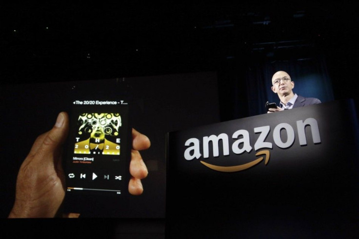 Amazon CEO Jeff Bezos shows off his company's new Fire smartphone at a news conference in Seattle, Washington June 18, 2014.