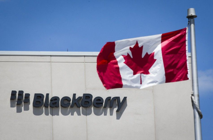 A Canadian Flag Is Pictured In Front Of A Blackberry Sign In Waterloo