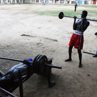 Bodybuilders lift weights at a sports centre in Juba