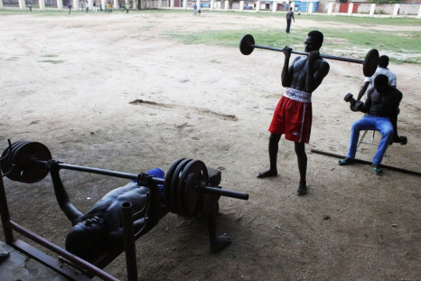 Bodybuilders lift weights at a sports centre in Juba