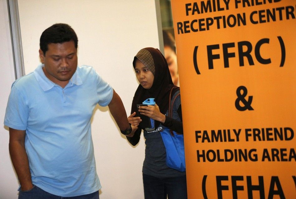 People, who said they believed their relatives were on Malaysia Airlines flight MH17, leave an area designated for family members while waiting for more information about the crashed plane at Kuala Lumpur International Airport in Sepang July 18, 2014. The