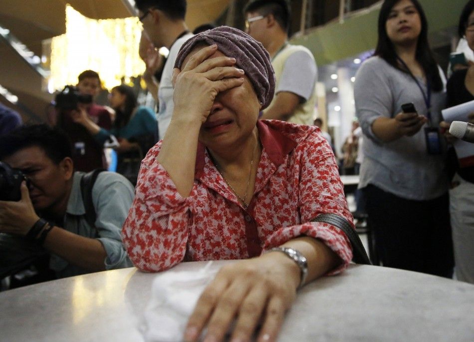 REFILE - CORRECTING BYLINE  A woman, who said she believed her sister was on Malaysia Airlines flight MH17, cries as she waits for more information about the crashed plane at Kuala Lumpur International Airport in Sepang July 18, 2014. The Malaysia Airline