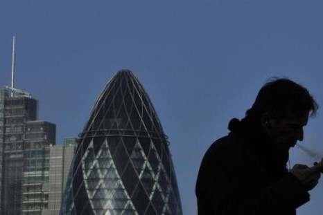A worker smokes a cigar in the City of London February 9, 2011.