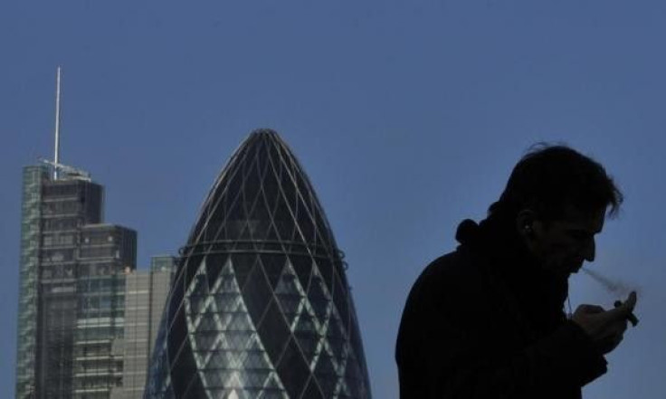 A worker smokes a cigar in the City of London February 9, 2011.