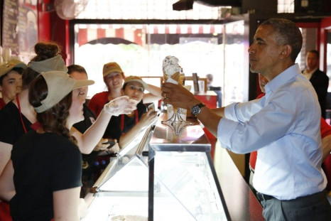 U.S. President Barack Obama buys an ice cream in the Grand Ole Creamery in St. Paul, Minnesota, June 26, 2014. 