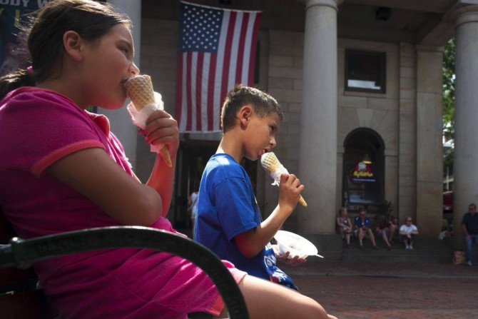 Two children eat ice cream cones at Quincy Marketplace on a summer's day in Boston, Massachusetts July 17, 2014. 