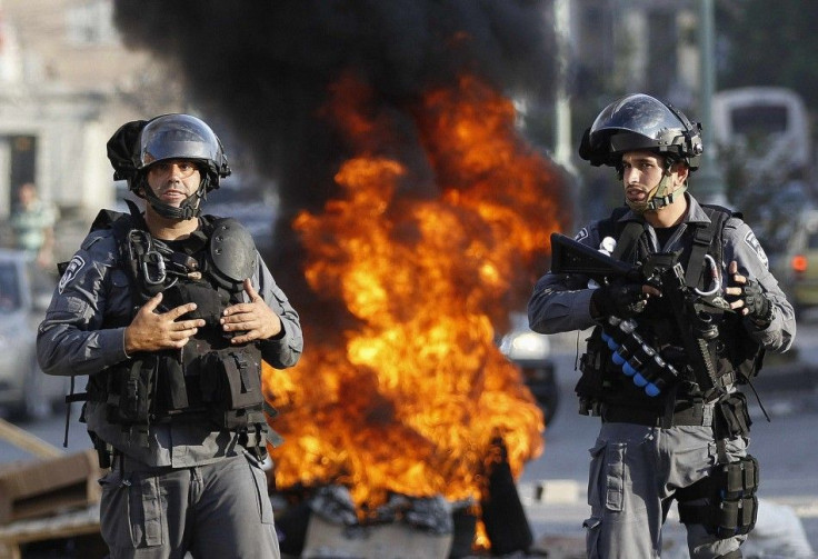 Israeli police officers stand guard during a protest by Israeli Arabs in the northern city of Nazareth, against Israel's offensive in the Gaza Strip