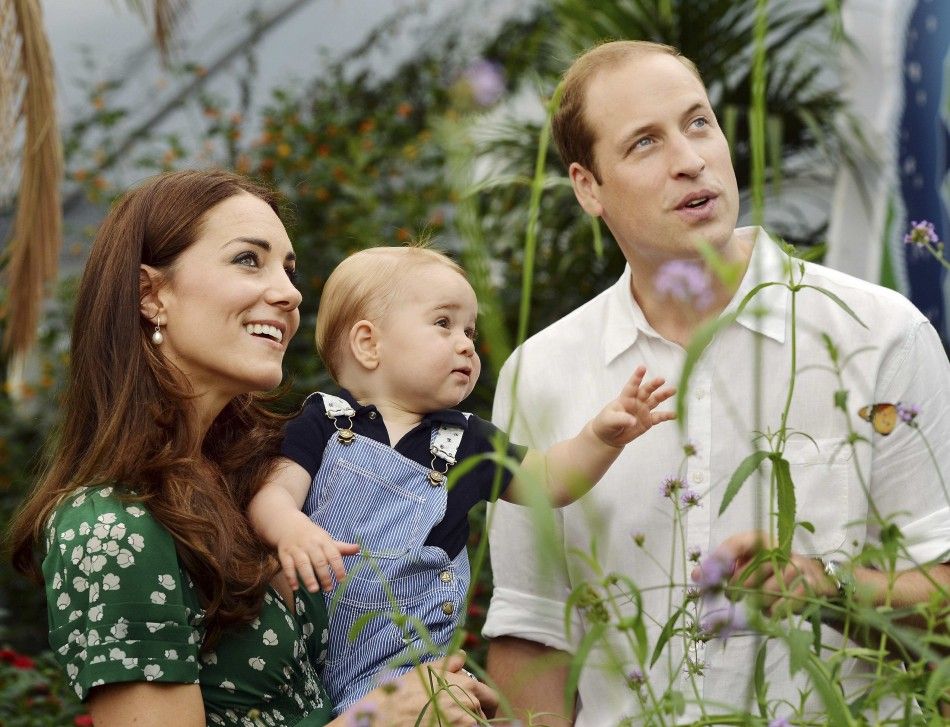 Britains Catherine, Duchess of Cambridge, carries her son Prince George alongside her husband Prince William as they visit the Sensational Butterflies exhibition at the Natural History Museum in London