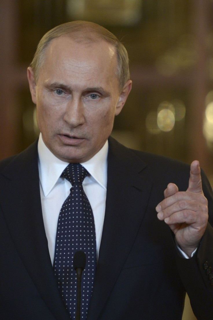 Russia's President Vladimir Putin talks to reporters during a meeting in Brasilia July 16, 2014