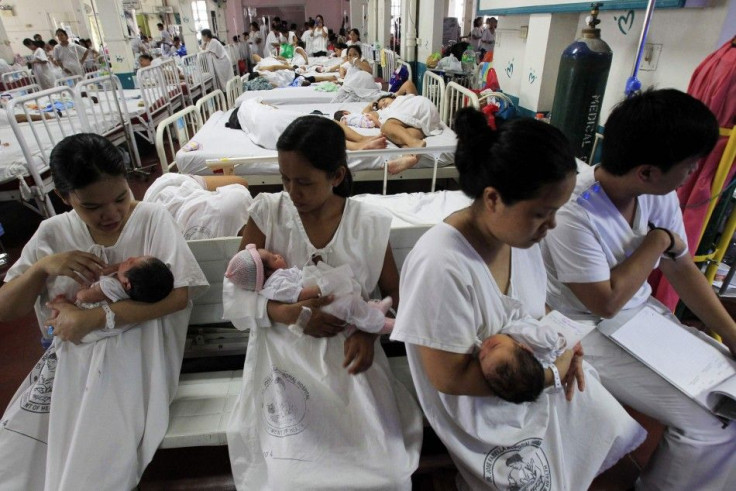 Mothers cradle their newborn babies before their check up inside a ward at Dr. Jose Fabella Memorial Hospital in Manila