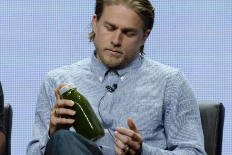 Cast member Hunnam of the drama series &quot;Sons of Anarchy&quot; shakes his juice as he participates in a panel discussion during FX Networks' portion of the 2014 Television Critics Association Cable Summer Press Tour in Beverly Hills