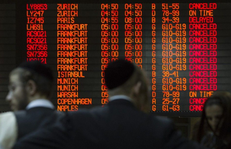 A departure time flight board displays various cancellations as passengers stand nearby at Ben Gurion International airport in Tel Aviv  July 22, 2014. The Federal Aviation Administration (FAA) banned U.S. carriers from flying to or from Ben Gurion Intern