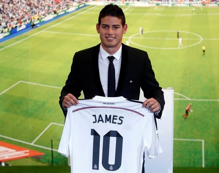 Colombias soccer player James Rodriguez holds up his new Real Madrid jersey during a presentation at the Santiago Bernabeu stadium in Madrid