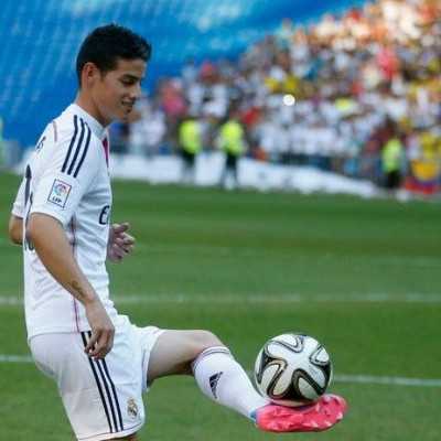 Colombia's soccer player James Rodriguez controls the ball during his presentation at the Santiago Bernabeu stadium in Madrid