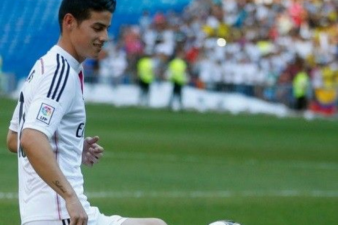 Colombia's soccer player James Rodriguez controls the ball during his presentation at the Santiago Bernabeu stadium in Madrid