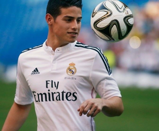 Colombias soccer player James Rodriguez controls the ball during his presentation at the Santiago Bernabeu stadium in Madrid