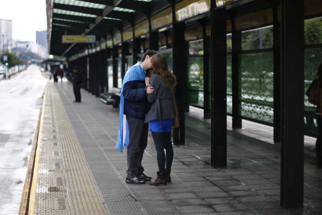 A couple kisses at a bus stop, before Argentina&#039;s World Cup final soccer match against Germany, in Buenos Aires