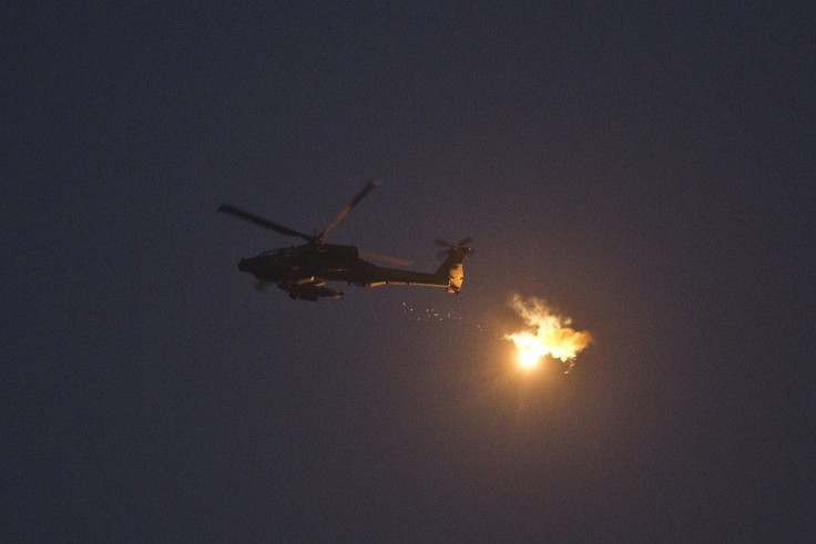 An Israeli Apache helicopter fires flares near the border with the northern Gaza Strip