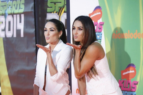 World Wrestling Entertainment (WWE) wrestlers, twins Brie (L) and Nikki Bella pose at the 2014 Nickelodeon Kids&#039; Choice Sports awards in Los Angeles July 17, 2014.