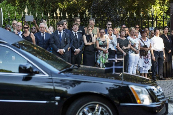 REFILE - ADDITIONAL INFORMATION  Family members of the victims killed in Malaysia Airlines Flight MH17 plane disaster react next to Mayor Pieter Broertjes (front 3rd L) as a row of hearses carrying the victims&#039; bodies arrives at the Korporaal van Oud