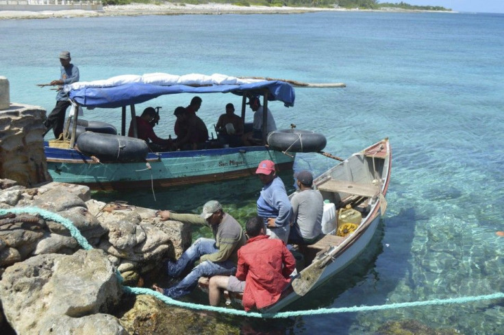 Two boats with 10 Cuban migrants are pictured anchored in Cayman Brac waters in this July 20, 2014 handout photo. The 10 migrants abandoned one of the boats and set out for Honduras in the other, but returned shortly after to drop off five of their number