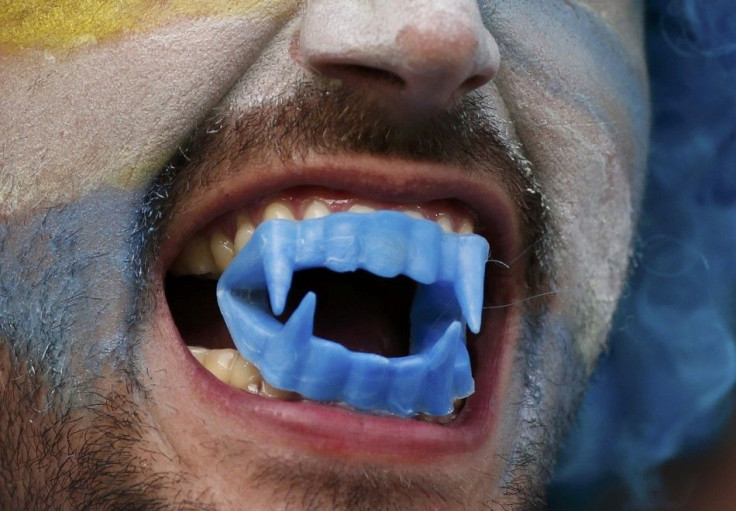 A Uruguay fan bares his teeth before the 2014 World Cup round of 16 game between Colombia and Uruguay at the Maracana stadium