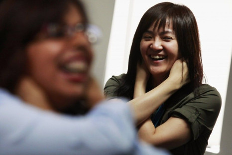 A staff member from Ocean Park hold her ears during a Laughter Yoga class.