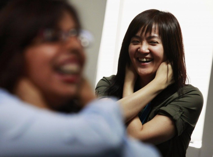 A staff member from Ocean Park hold her ears during a Laughter Yoga class.