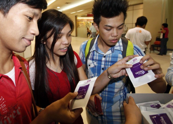 Students receive free condoms at an event organised by the United Nations