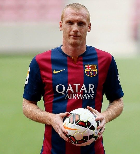 Barcelonas newly signed French soccer player Jeremy Mathieu poses while wearing his new jersey during his presentation at Camp Nou stadium, in Barcelona